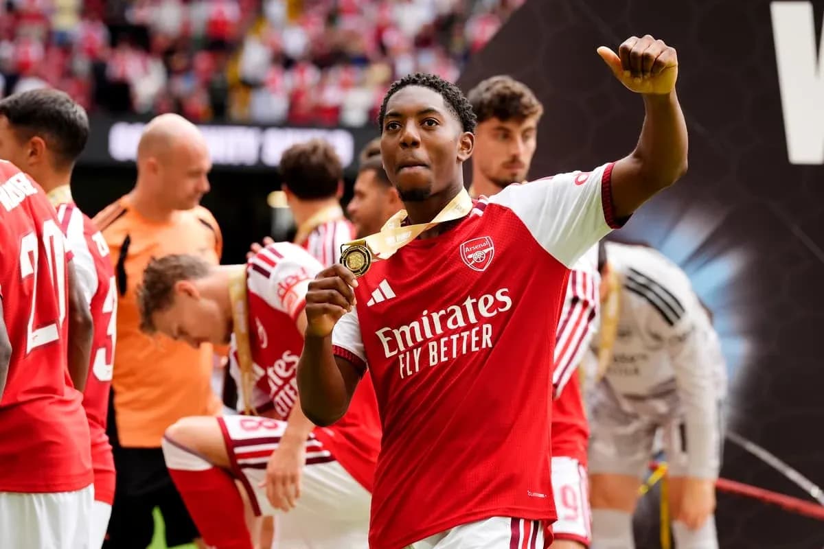 Arsenal player celebrating with medal after match