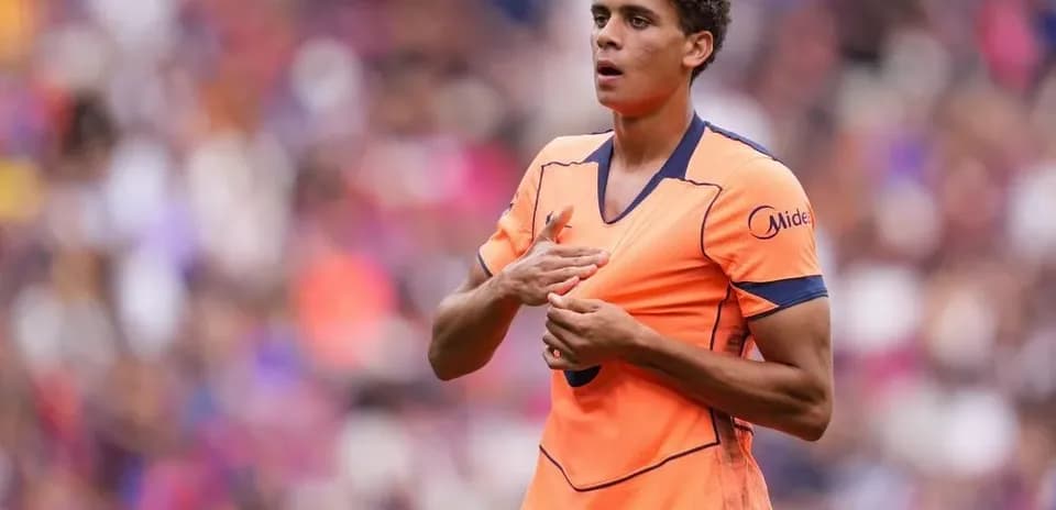 Player in orange jersey during match on field