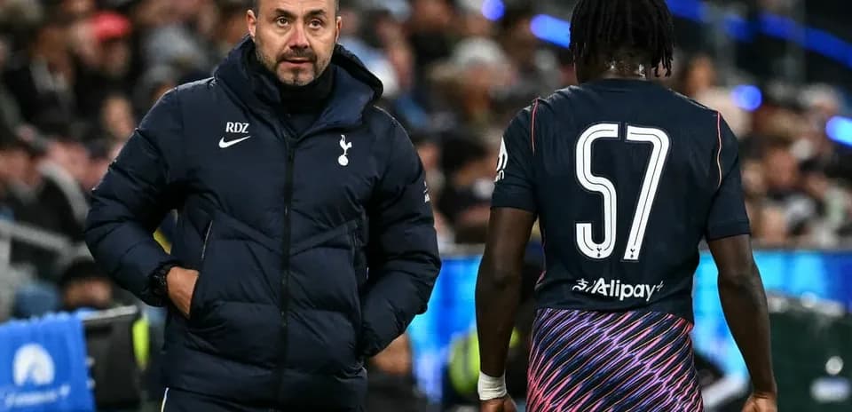 Tottenham coach interacting with player during match