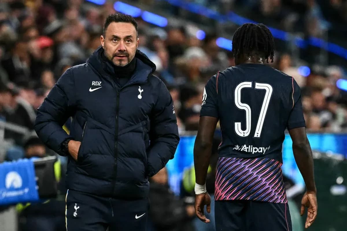 Tottenham coach interacting with player during match