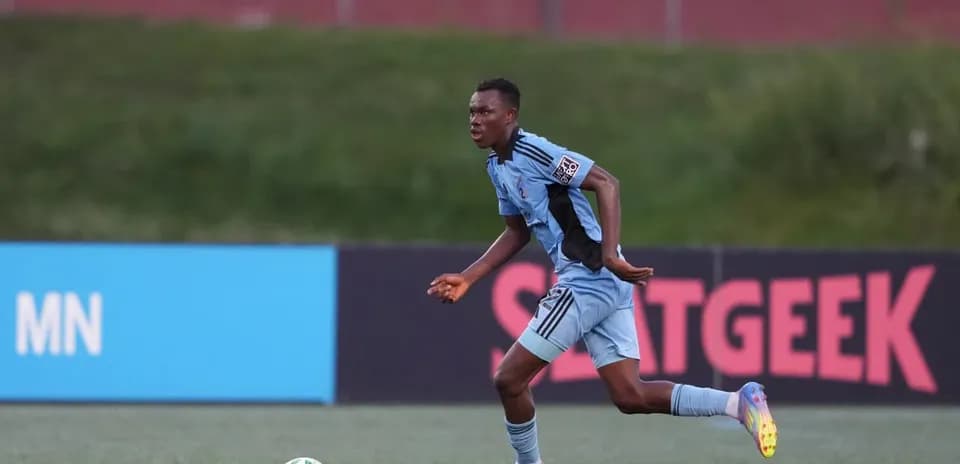 Player in blue jersey running with the ball