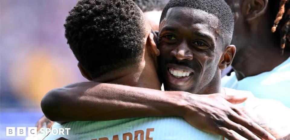 Players celebrating with an embrace on the field