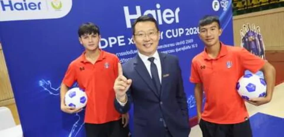 Two young players with a representative at event