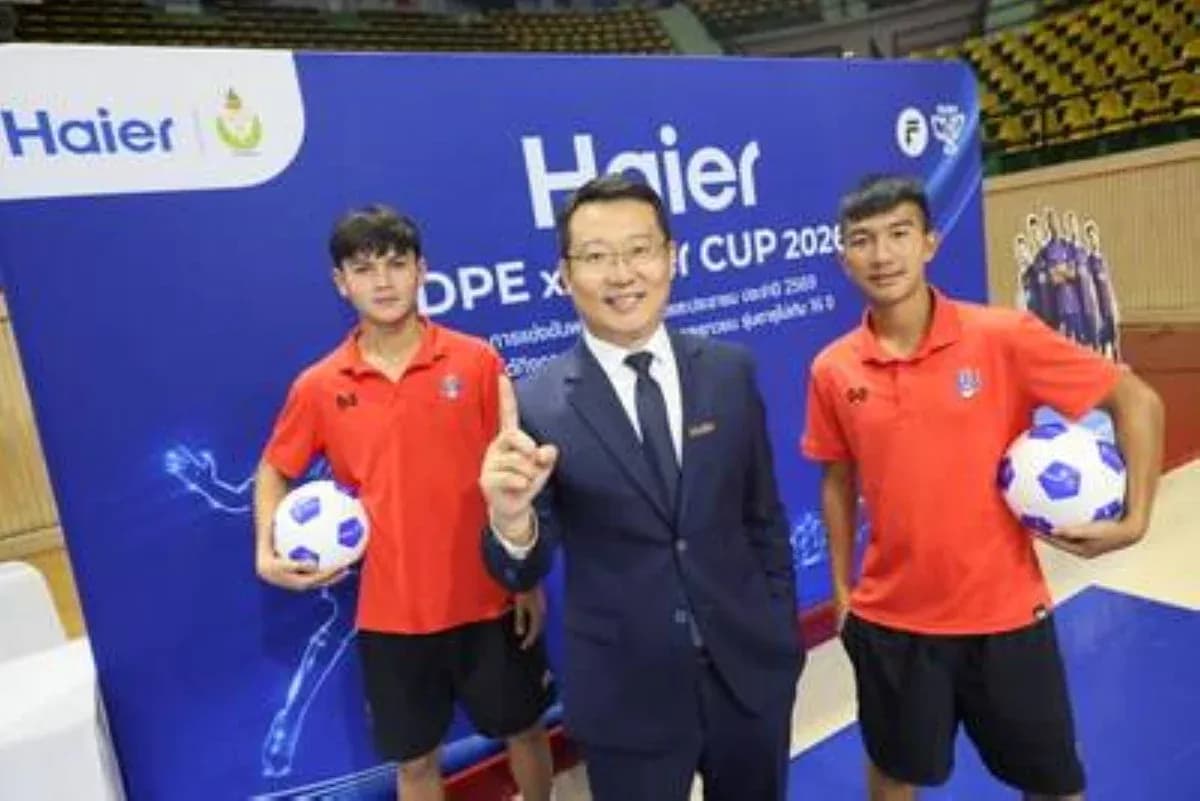 Two young players with a representative at event