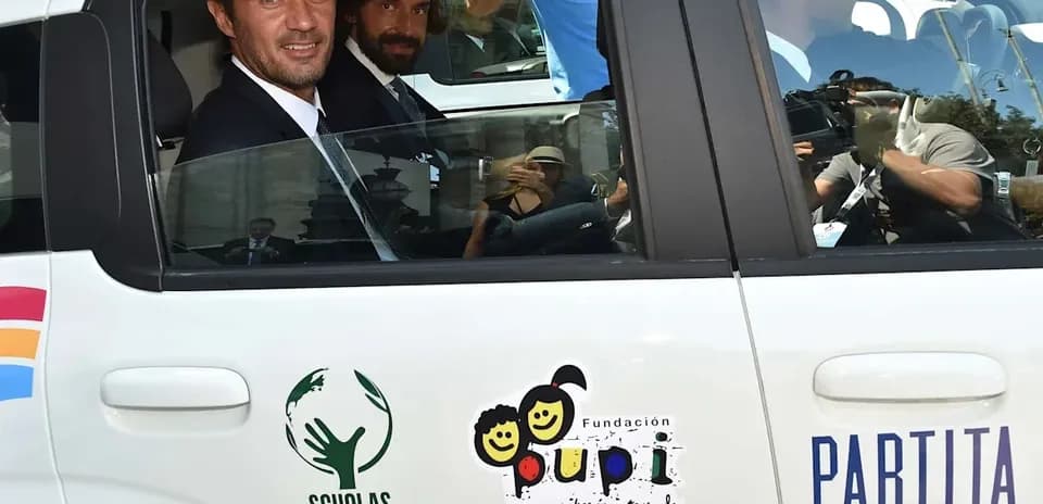 Two men seated in a car during event