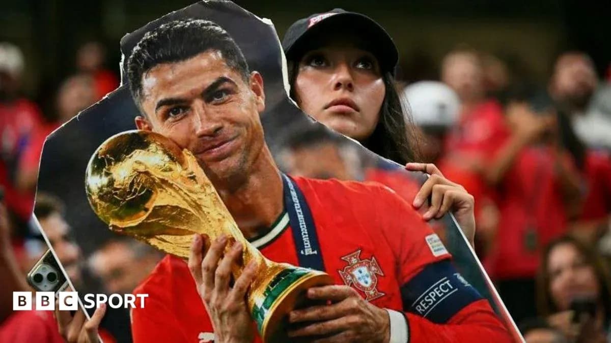 Fan holding cutout of player with trophy Fan holding cutout of player with trophy