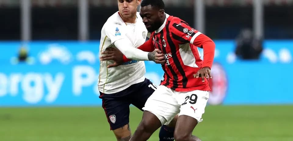 AC Milan player battling for the ball against Cagliari
