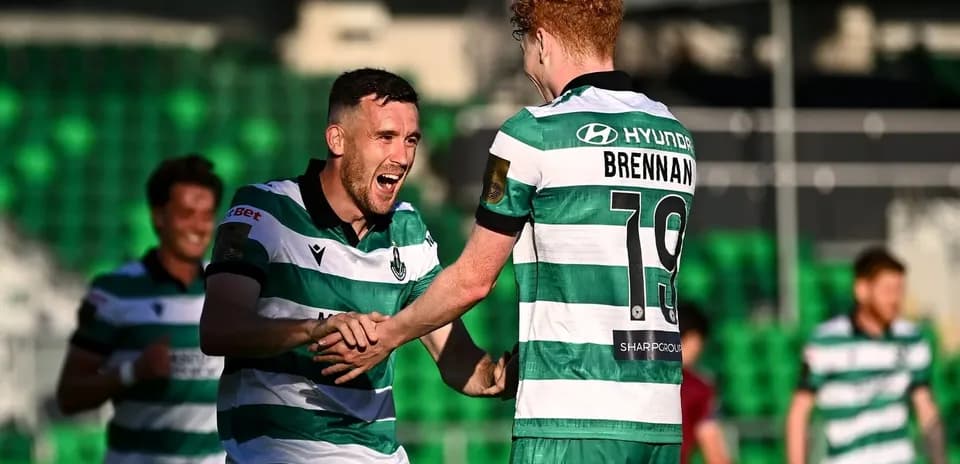 Two players celebrating a goal on the field