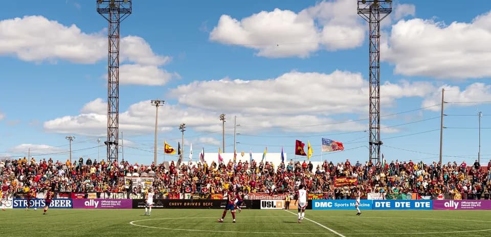 Detroit City players on field with fans in background