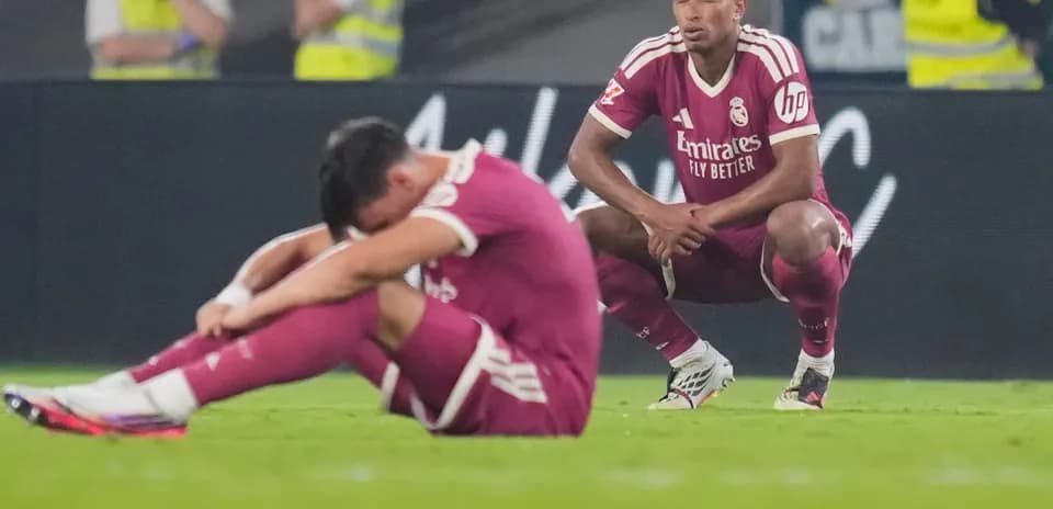 Real Madrid players sitting dejected on the field