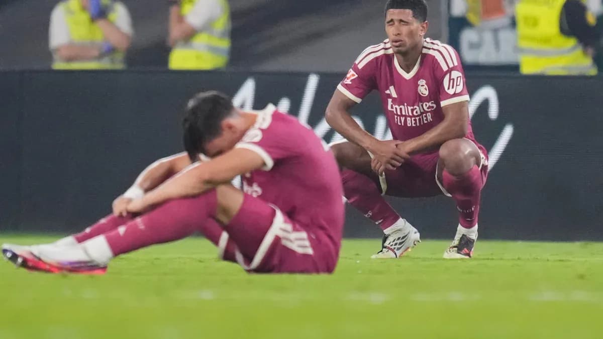 Real Madrid players sitting dejected on the field