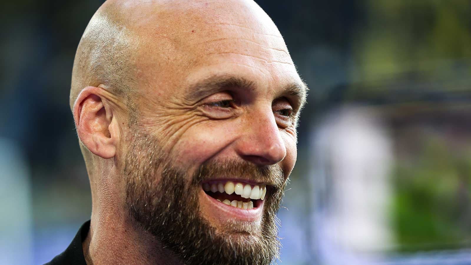 Smiling man with a beard at an event