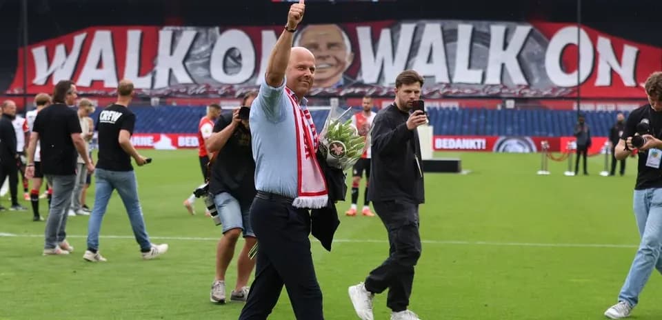 Man waving with flowers on football pitch