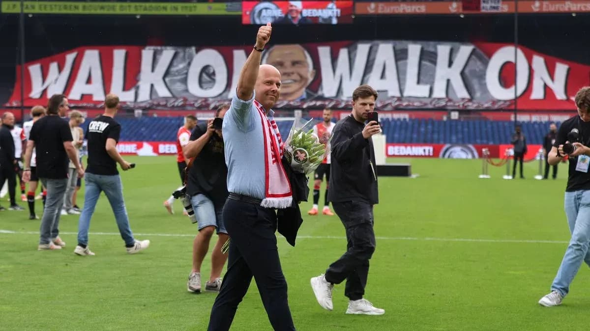 Man waving with flowers on football pitch