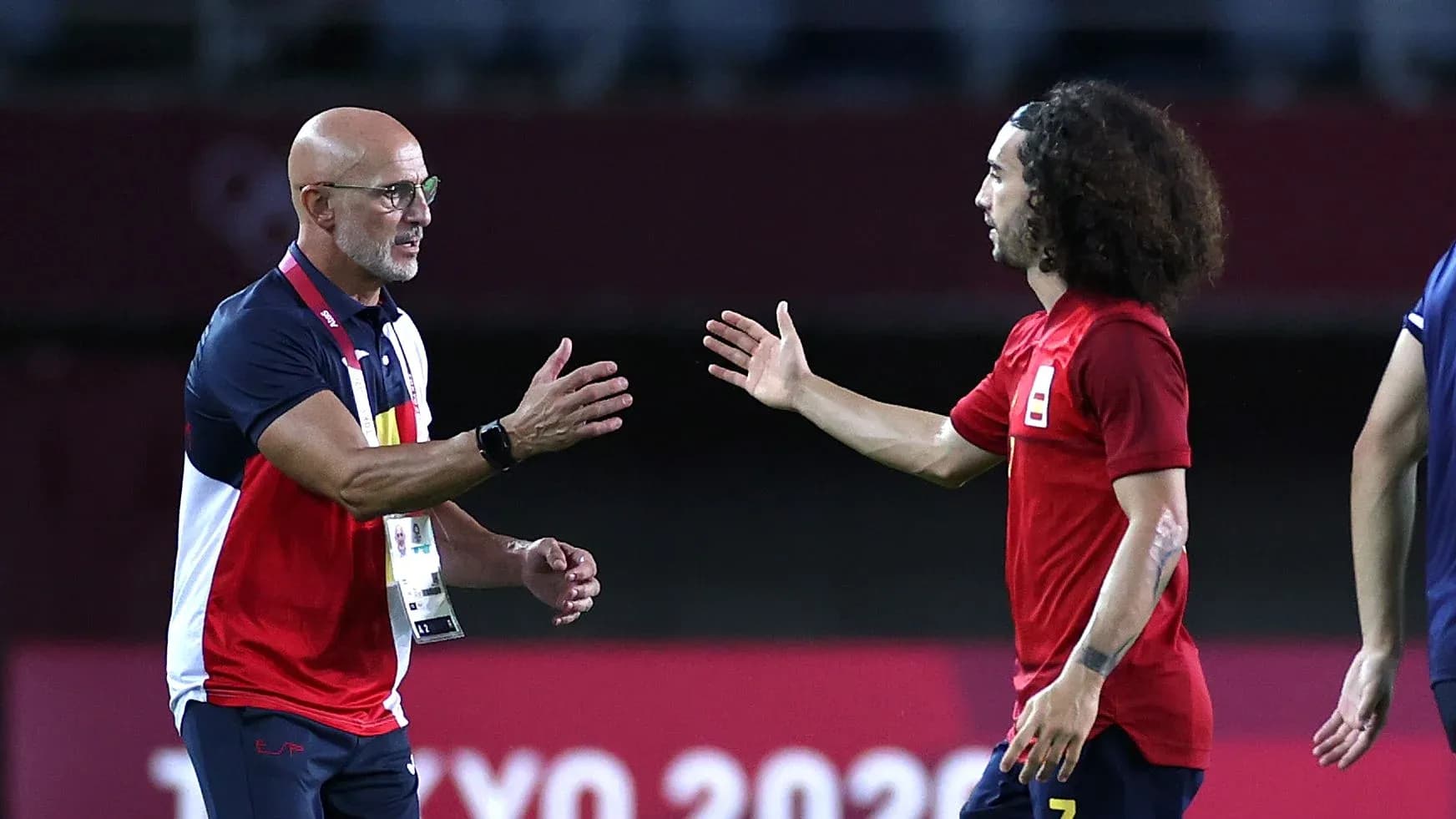 Coach and player shaking hands on the field