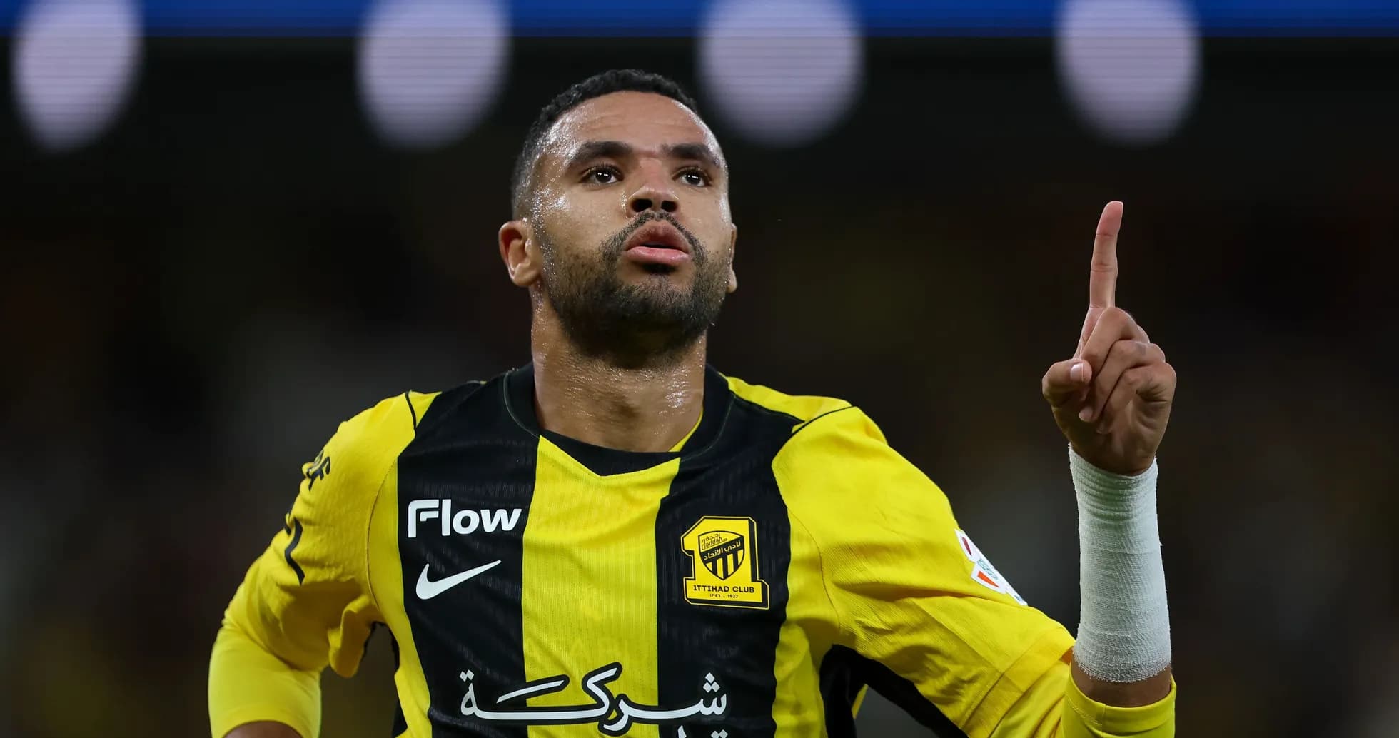 Player celebrating a goal wearing yellow and black jersey