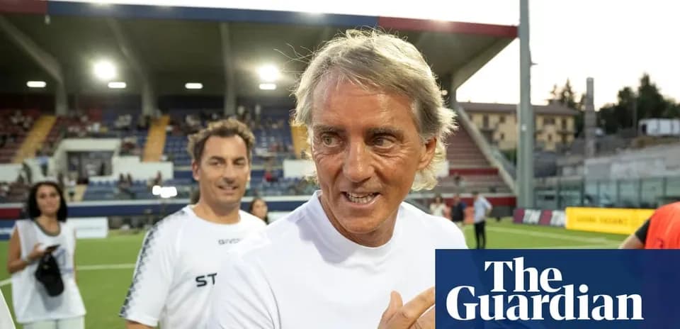 Coach smiling on the pitch after a match