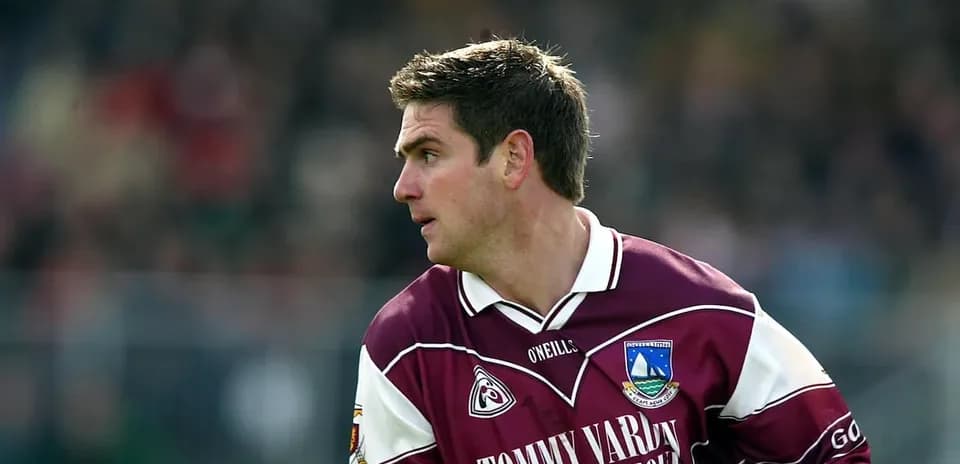 Player in maroon jersey preparing for play