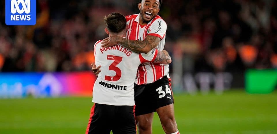 Two players celebrating a victory on the pitch