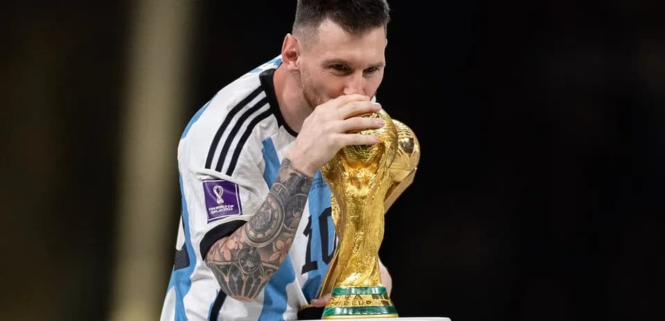 Player holding and kissing FIFA World Cup trophy