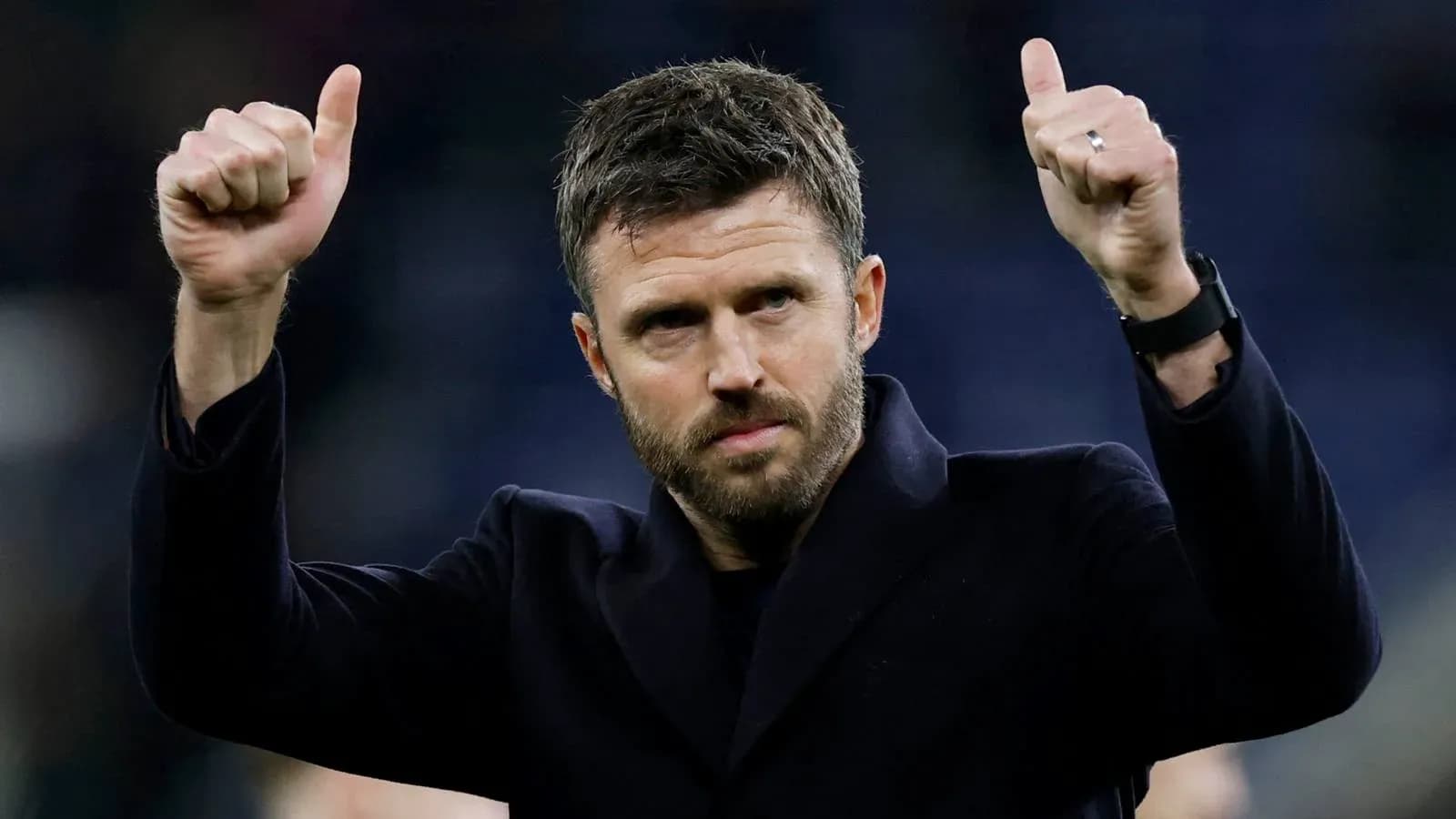 Man giving thumbs up gesture on field
