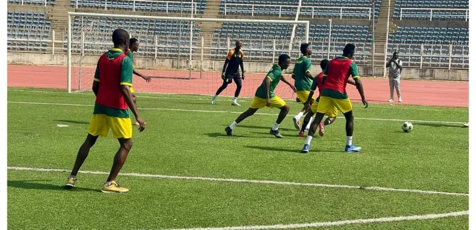 Players training on the pitch before match