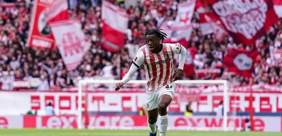 Player running with ball in front of cheering fans