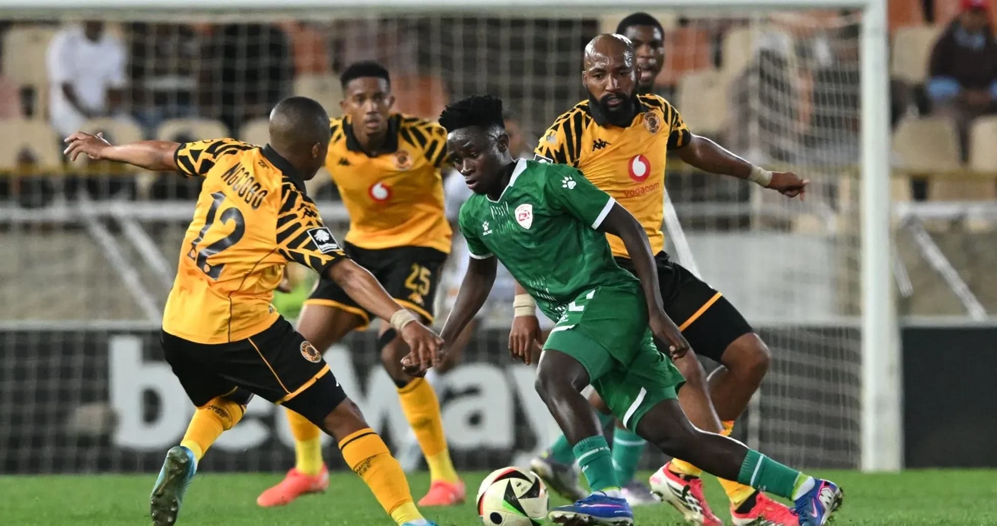 Players contesting for the ball during football match