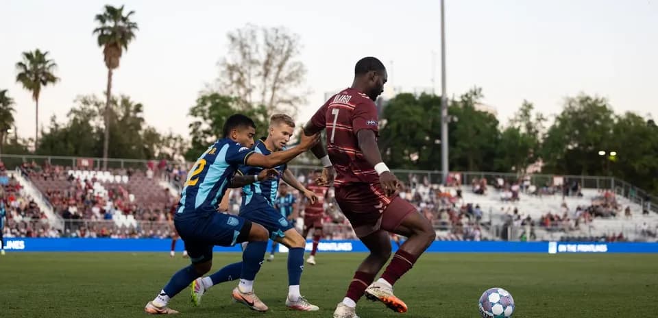 Player dribbling the ball in football match