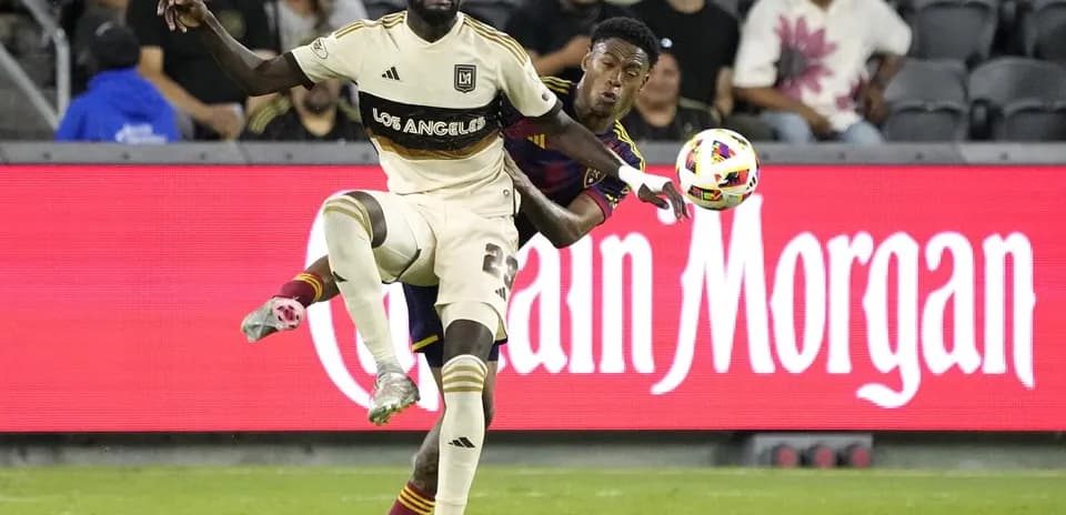 Players competing for the ball in MLS match