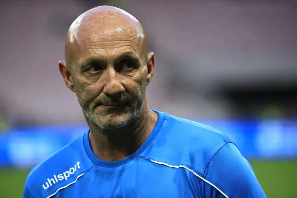 Coach in blue training shirt on field