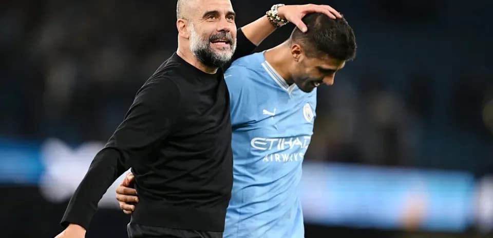 Coach and player celebrating after match at stadium