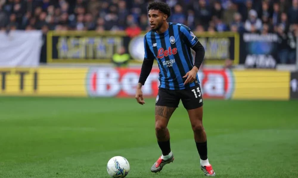 Player in Atalanta kit controlling the ball on field