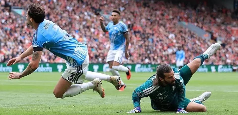 Goalkeeper diving for the ball during match action
