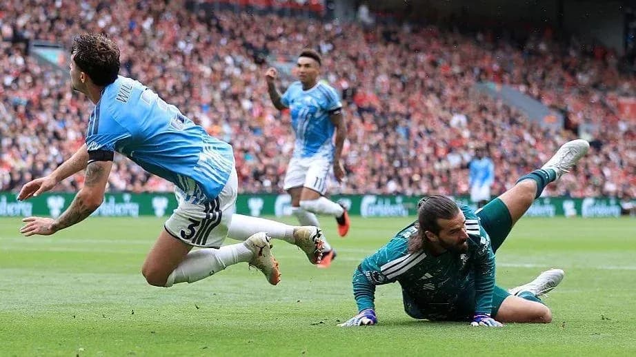 Goalkeeper diving for the ball during match action