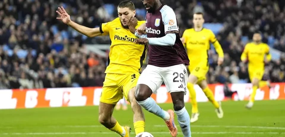 Player dribbling the ball while being challenged