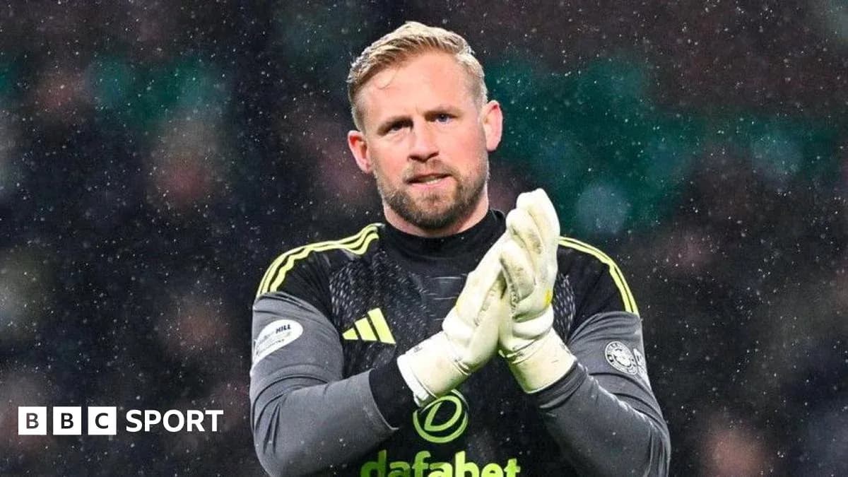 Goalkeeper clapping in snowy match atmosphere