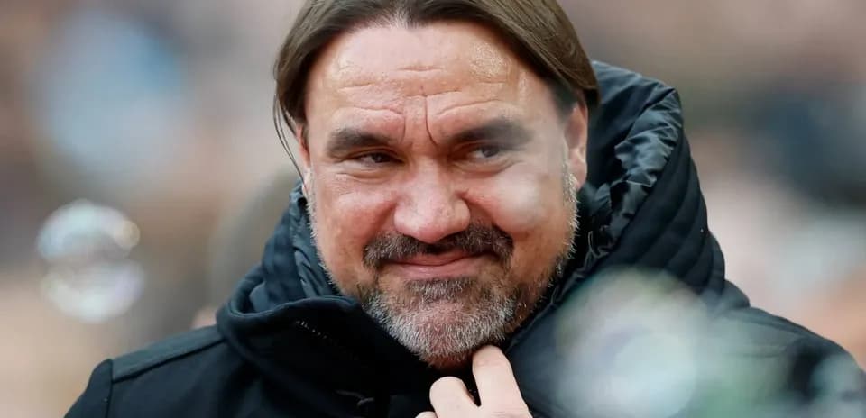 Coach smiling while wearing a black jacket