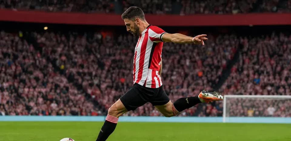 Player taking a free kick on the field