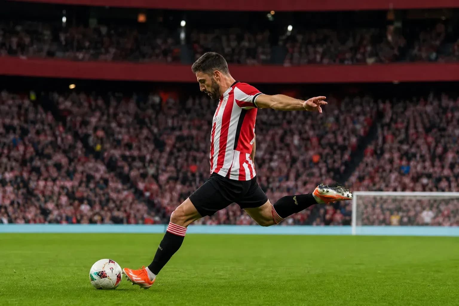 Player taking a free kick on the field