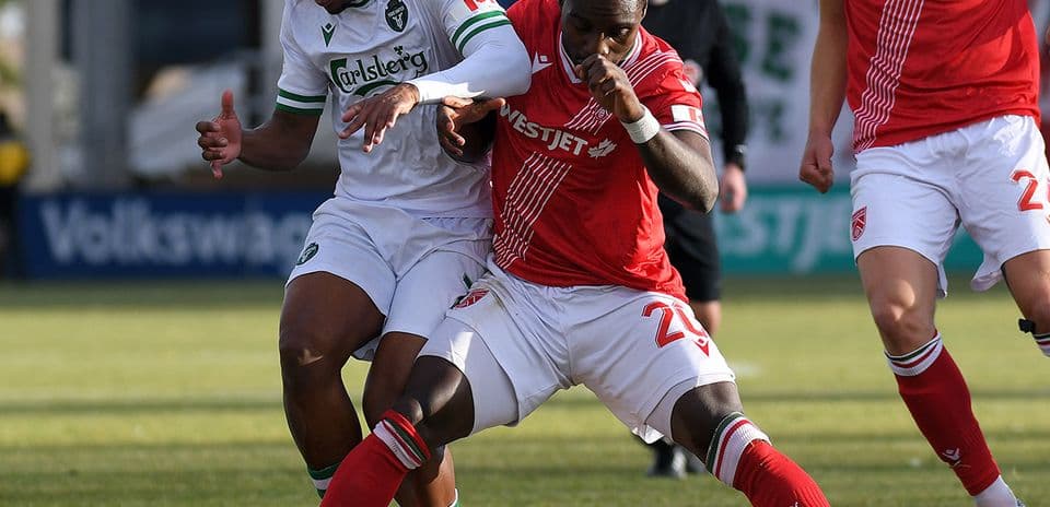 Two players battling for the ball during match