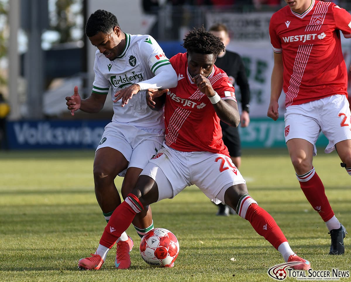Two players battling for the ball during match