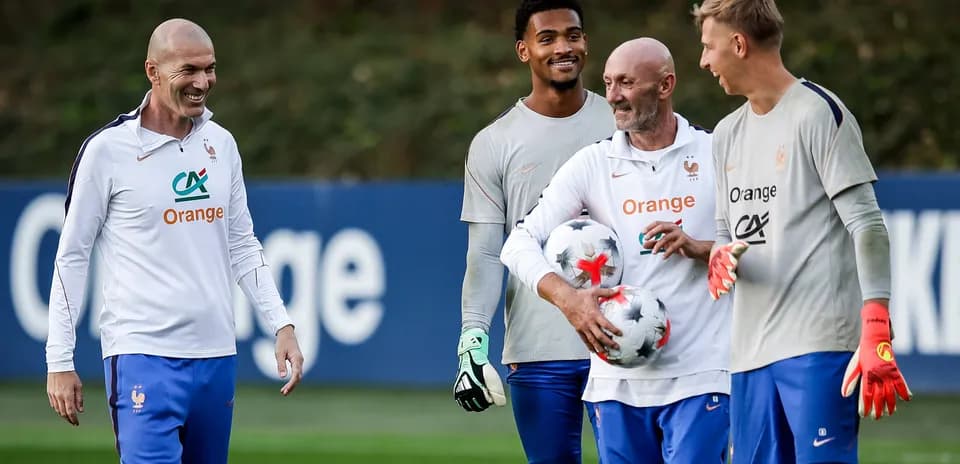 French football team training session with players and coach