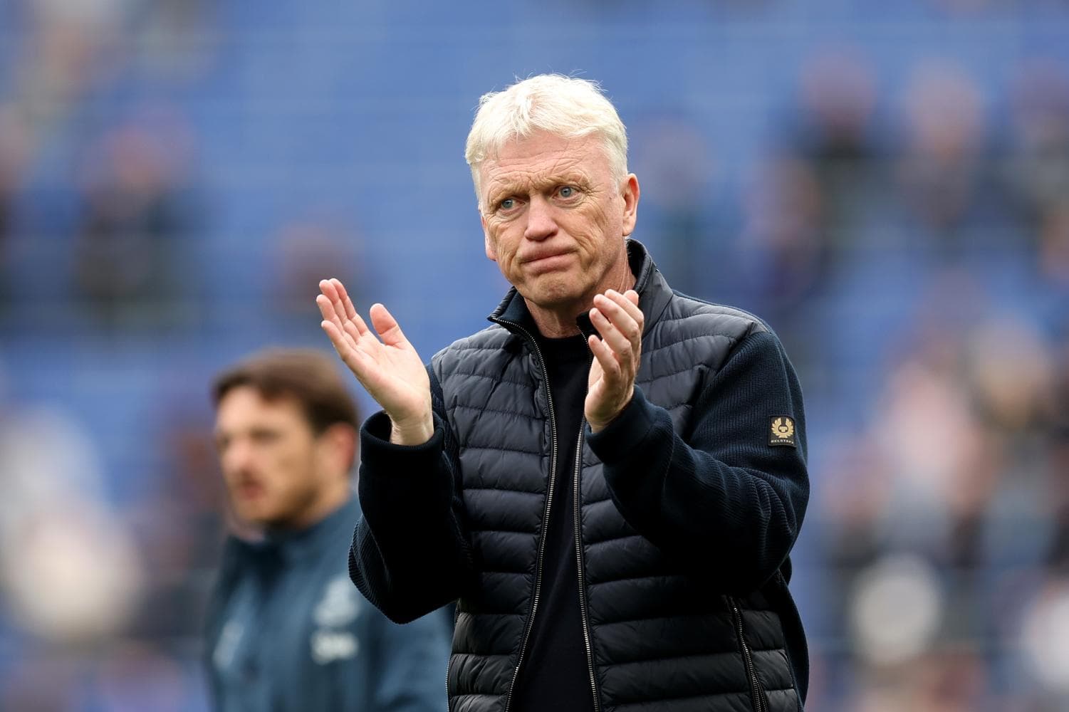 Manager applauding during a match on the sidelines