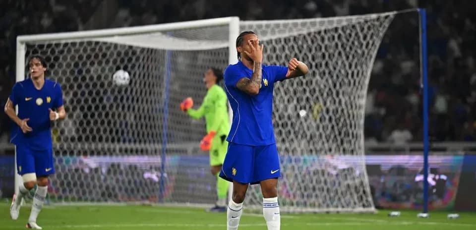 Player reacting during football match with goal in background