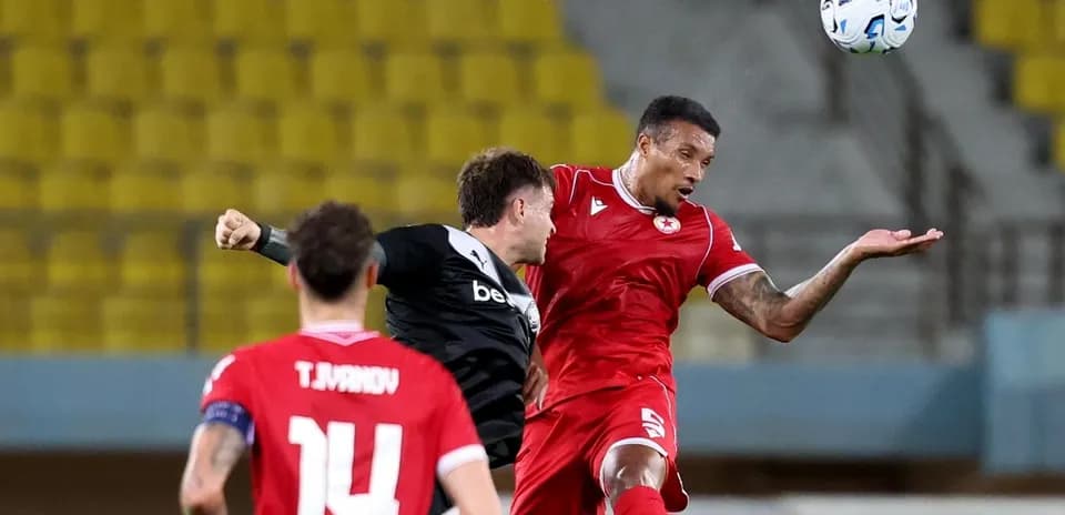 CSKA Sofia player challenging OFI player for ball