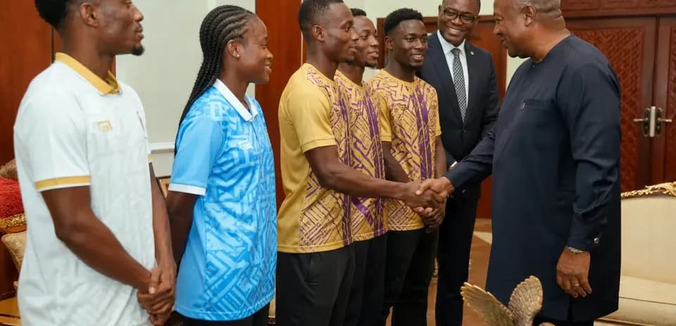 Athletes meeting official, shaking hands in office