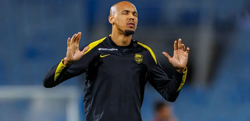 Player warming up with hands raised before match