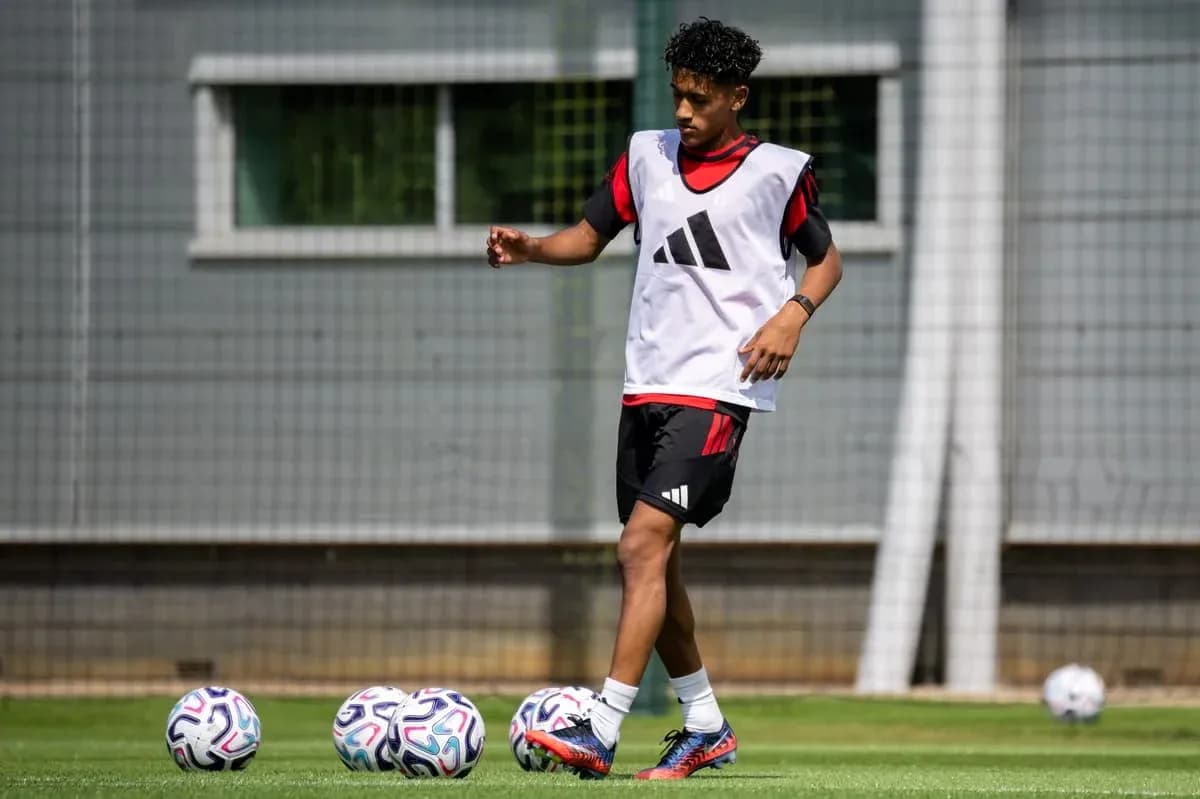 Player training with soccer balls on field