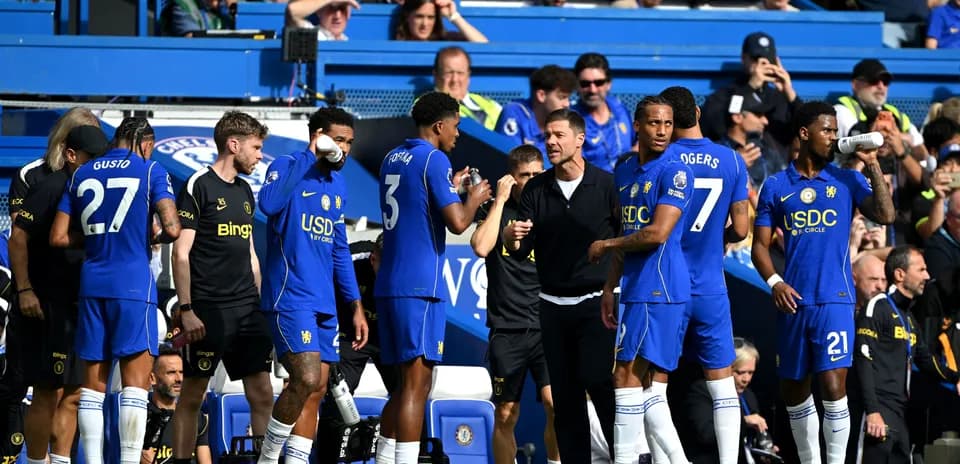 Chelsea players discussing tactics on the sidelines